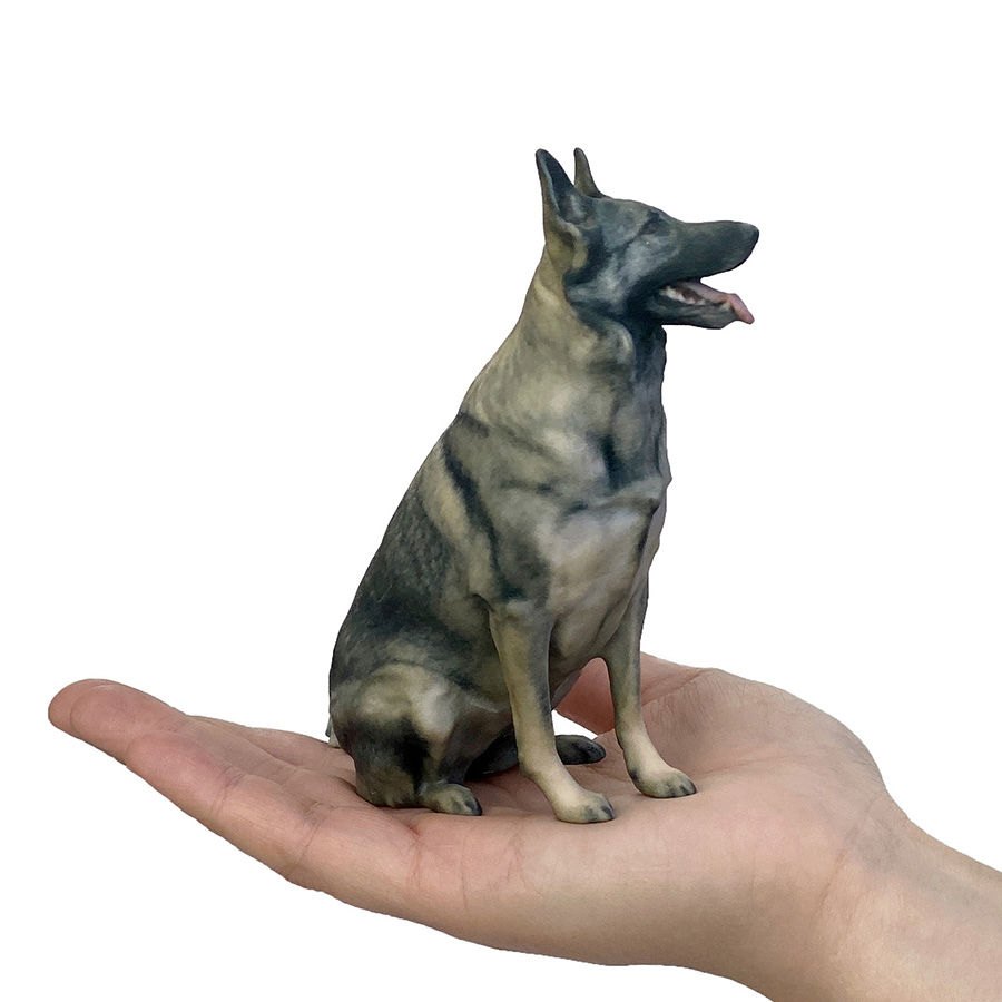 A full colour 3D printed dog figurine held in a hand, by GravityB 3D